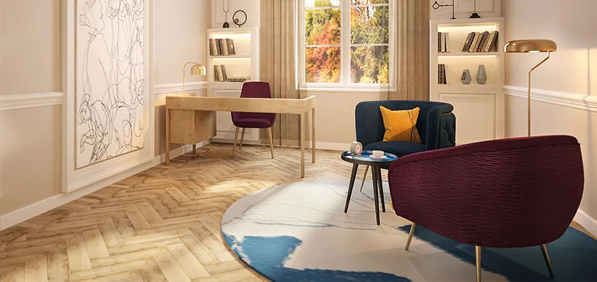 Therapy room with a herringbone parquet floor, a round rug, armchairs, a desk and wall shelves